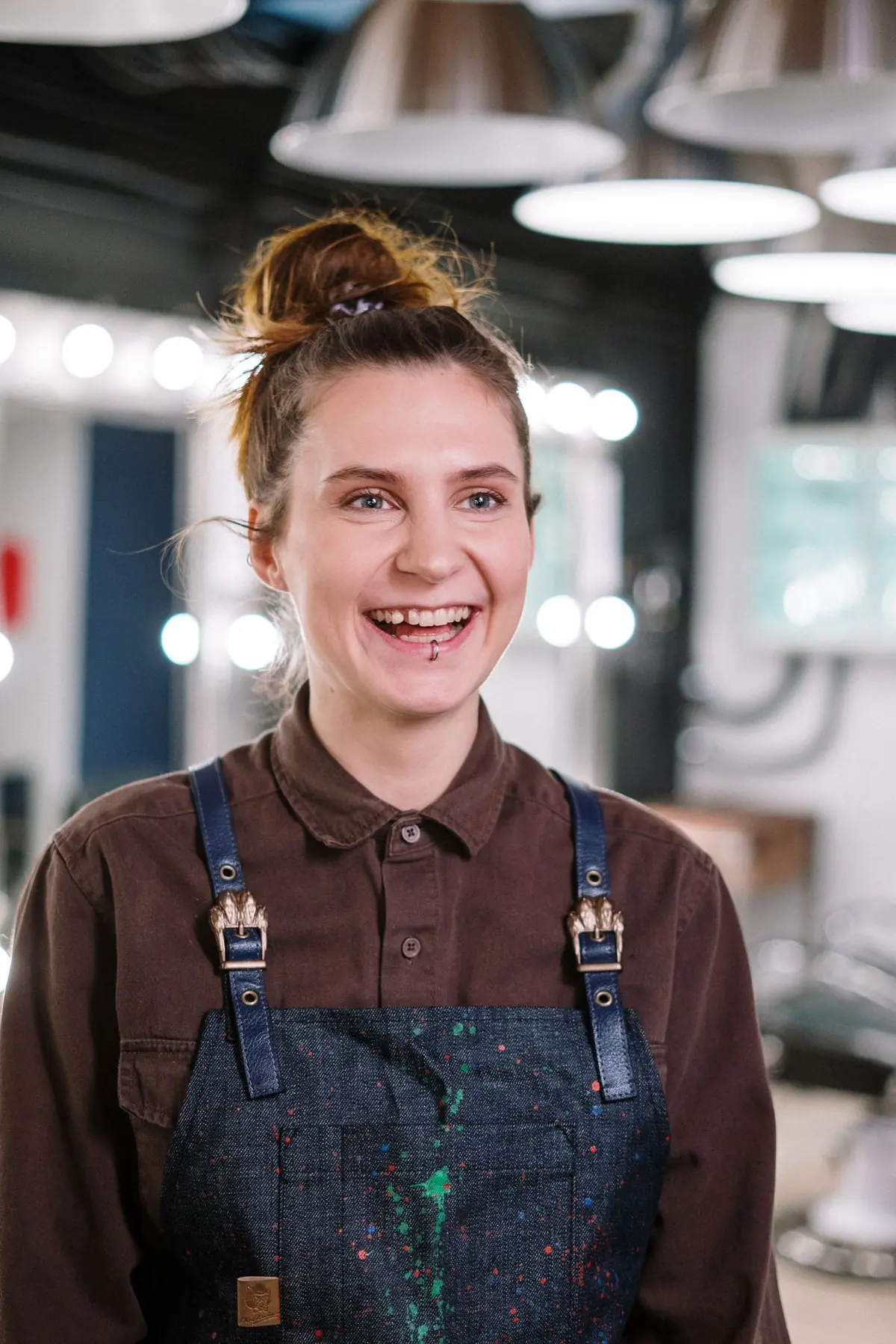 A woman laughing in a hair salon